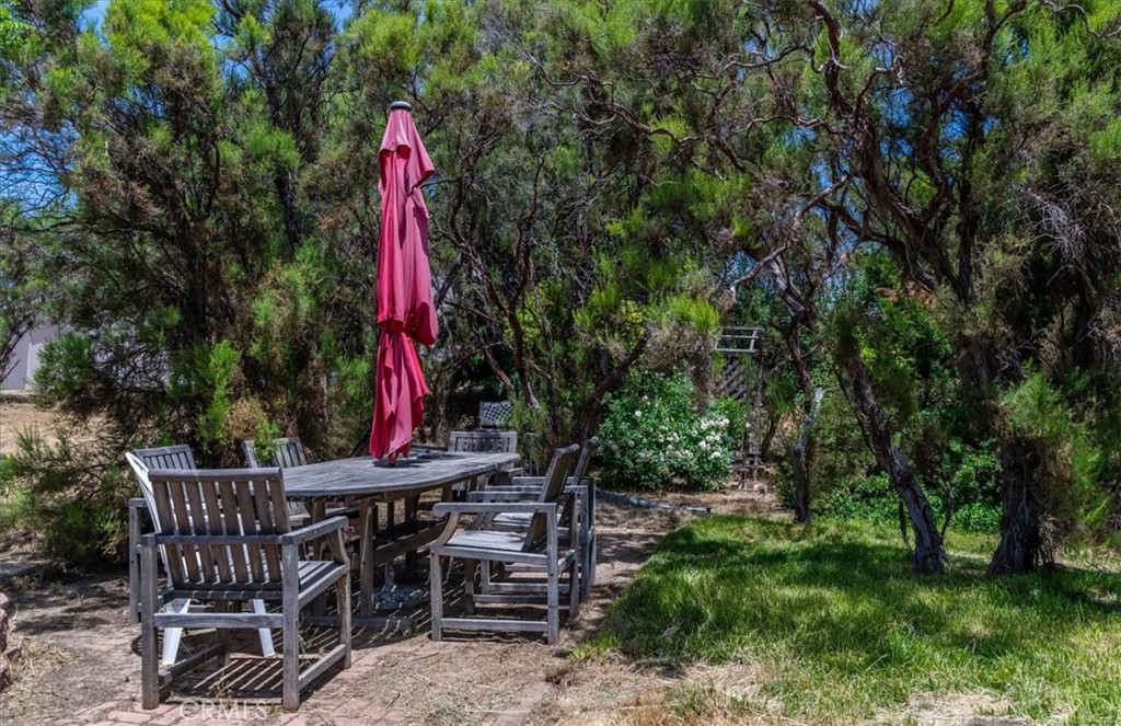 39875 Bautista Road Anza, CA 92539 - Photo 38 of 44 a view of a backyard with table and chairs and wooden fence