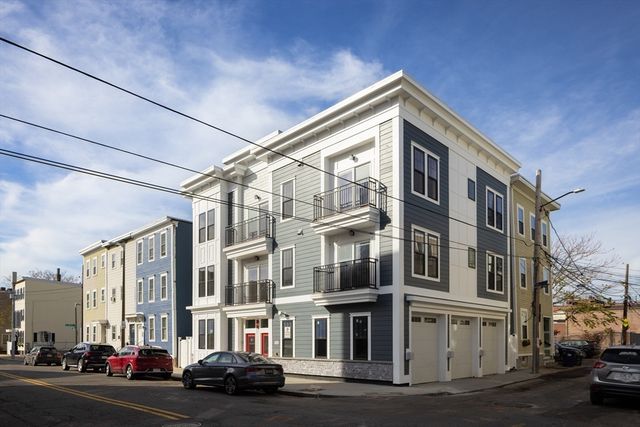 a couple of cars parked in front of brick building