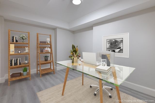 a view of a workspace with furniture and wooden floor