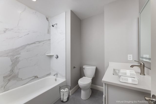 a white toilet sitting next to a bath tub