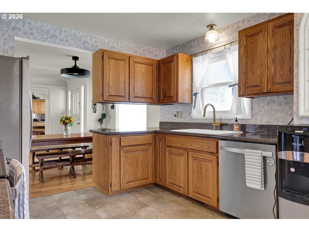 1355 Juniper Street Junction City, OR 97448 - Photo 14 of 45 a kitchen with kitchen island granite countertop a sink cabinets and wooden floor
