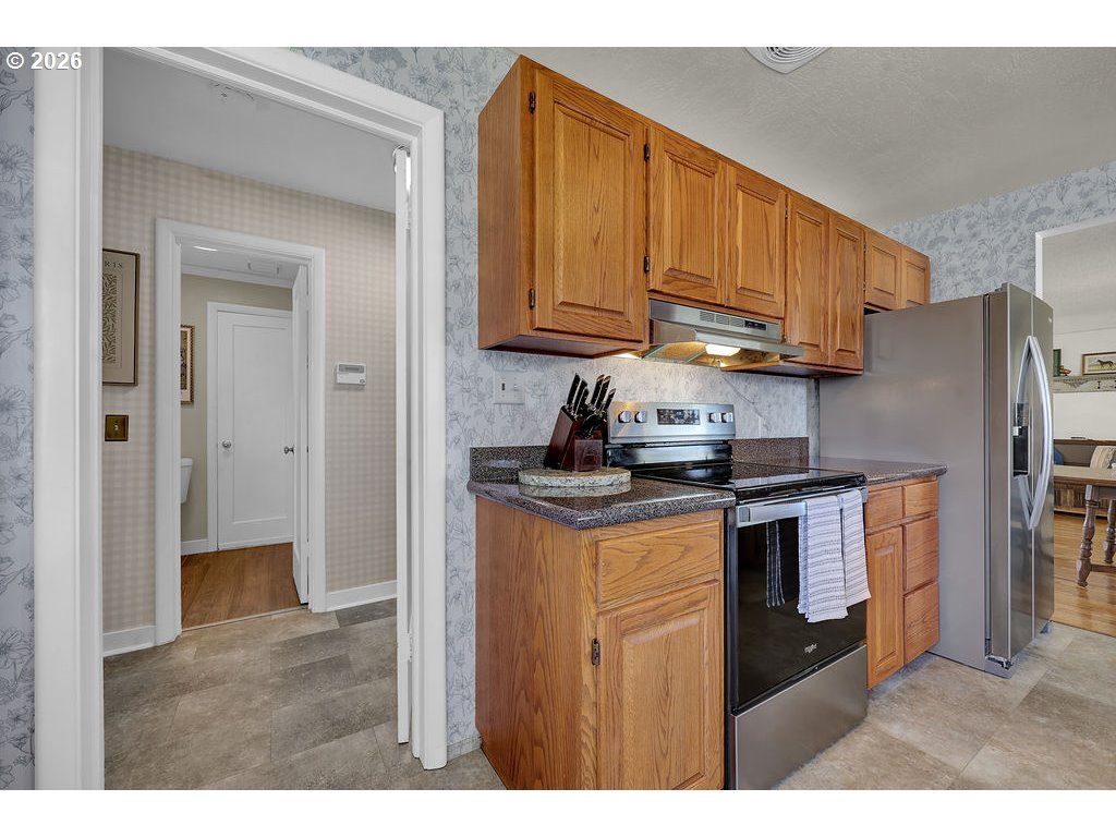 1355 Juniper Street Junction City, OR 97448 - Photo 15 of 45 a kitchen with stainless steel appliances granite countertop a refrigerator a stove a sink and dishwasher