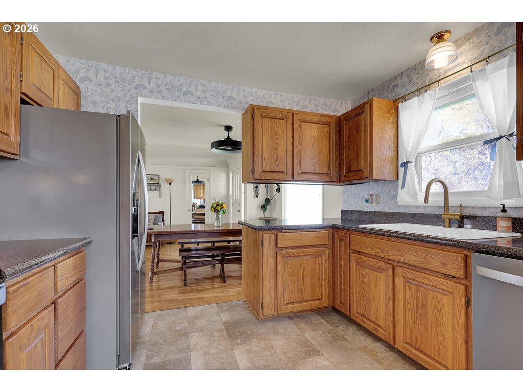 1355 Juniper Street Junction City, OR 97448 - Photo 16 of 45 a kitchen with kitchen island granite countertop a sink cabinets and stainless steel appliances