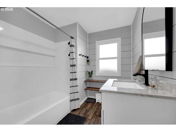 a bathroom with a sink a mirror and a bathtub