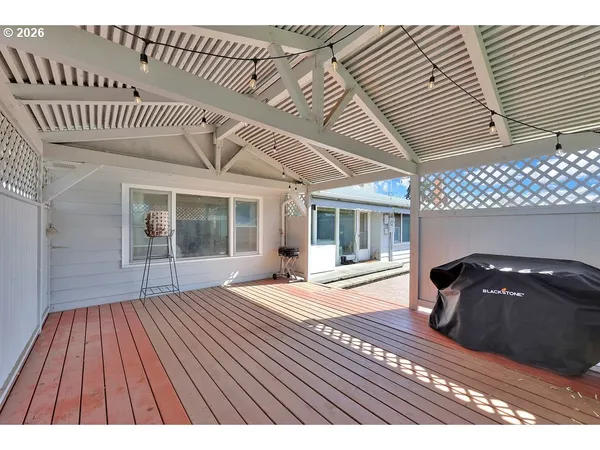 a view of a backyard with table and chairs and potted plants