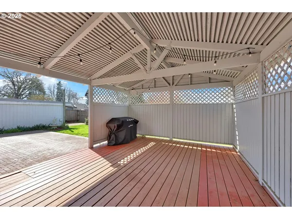 a backyard of a house with table and chairs
