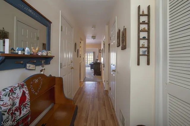 a view of hallway with wooden floor and stairs
