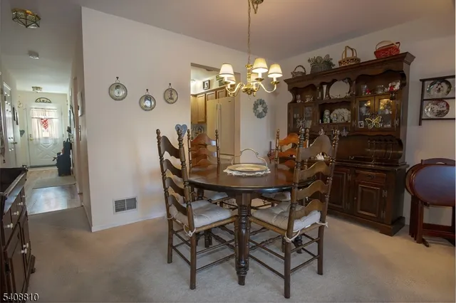 a view of a dining room with furniture and chandelier