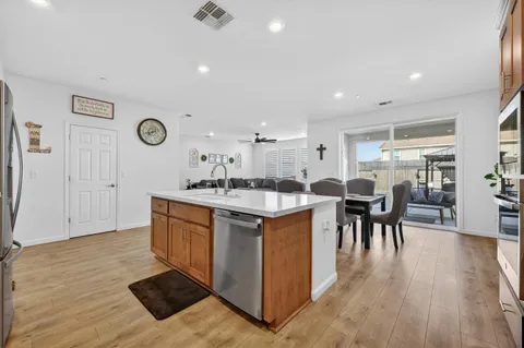 a kitchen with a sink cabinets and wooden floor