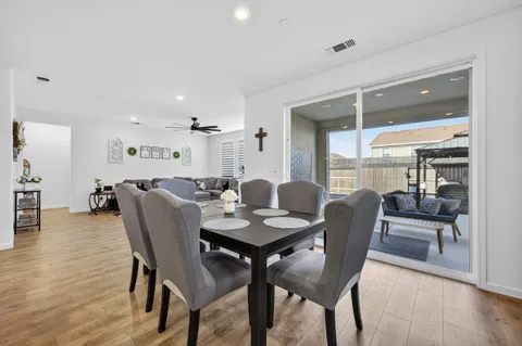 a living room with furniture a dining table and kitchen view
