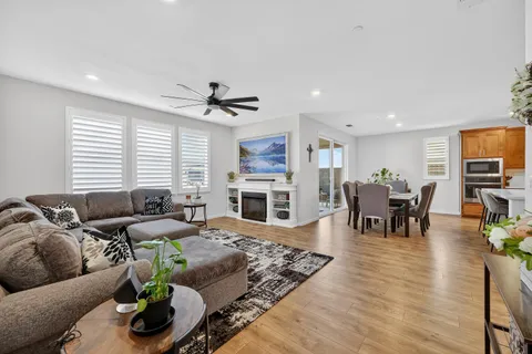 a bedroom with a large bed a couch and a chandelier
