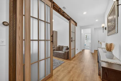 a hallway with furniture and wooden floor