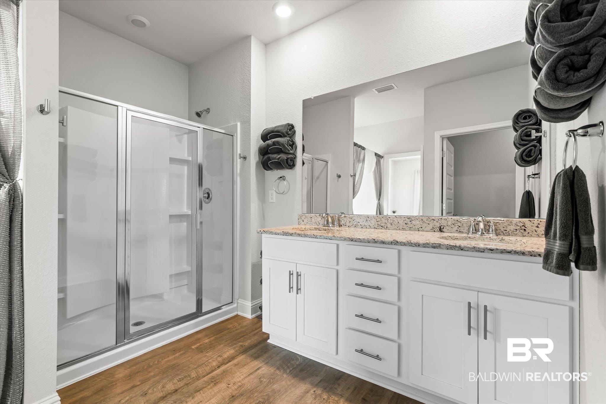 23246 Lieutenant Avenue Foley, AL 36535 - Photo 19 of 36 Bathroom with hardwood / wood-style flooring, vanity, and a shower with door