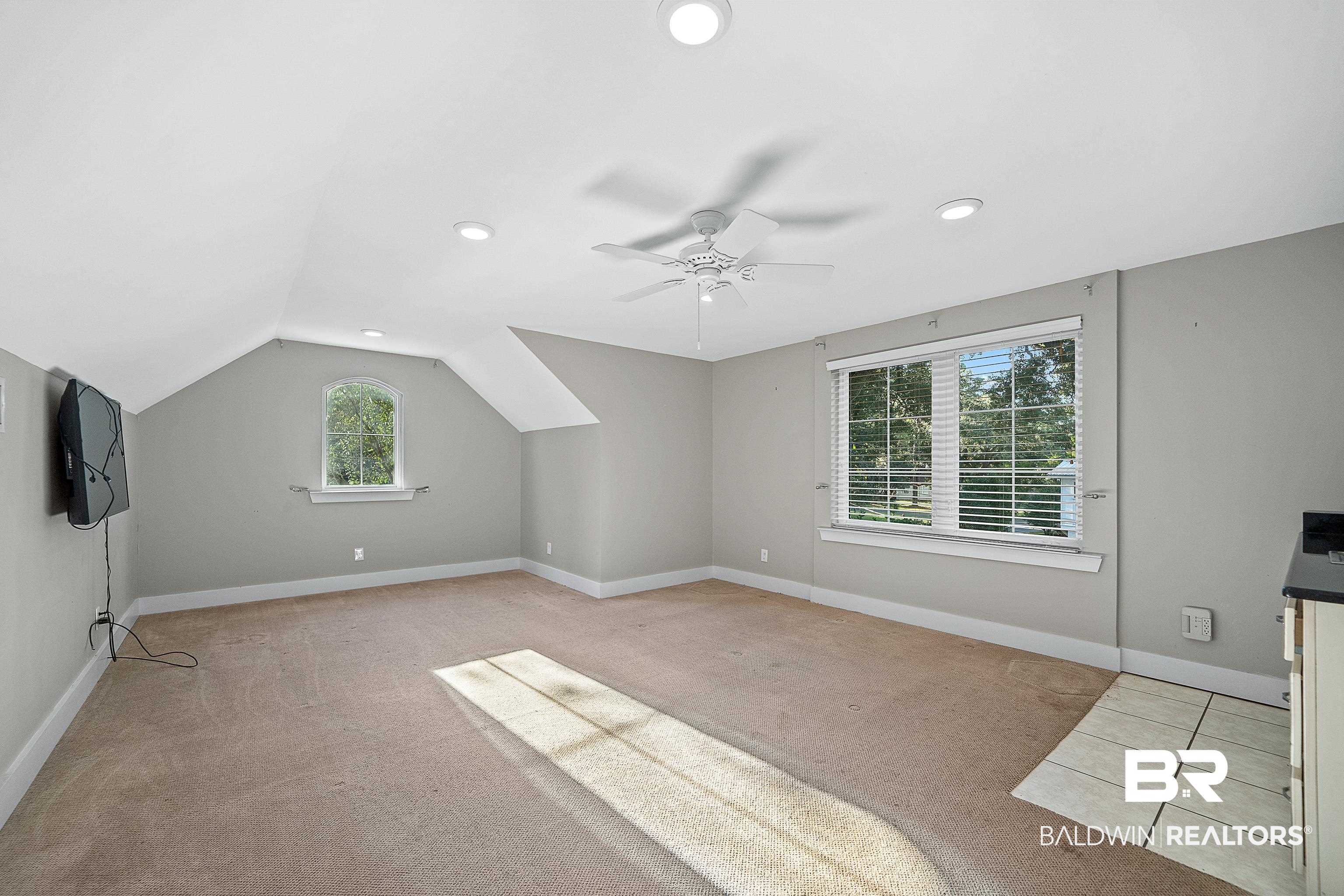 356 Liberty Street Fairhope, AL 36532 - Photo 25 of 39 Bonus room featuring light colored carpet, vaulted ceiling, a ceiling fan, and recessed lighting