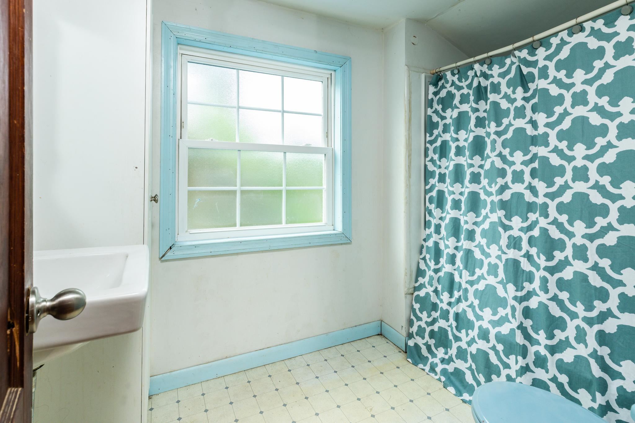 1762 Mt Torrey Road Lyndhurst, VA 22952 - Photo 32 of 46 a bathroom with a window toilet and shower