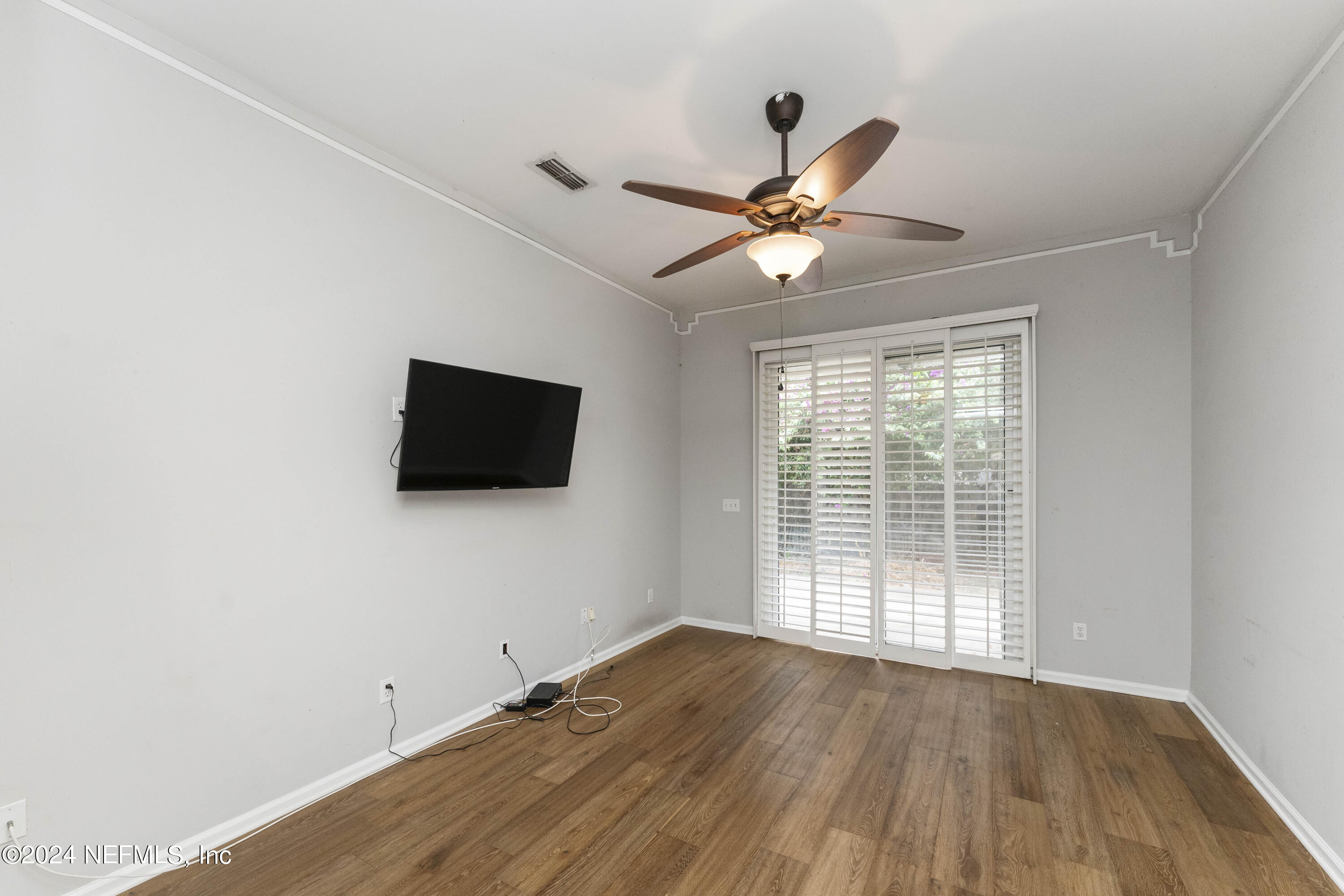 587 Selva Lakes Circle Atlantic Beach, FL 32233 - Photo 12 of 31 wooden floor in an empty room with a window