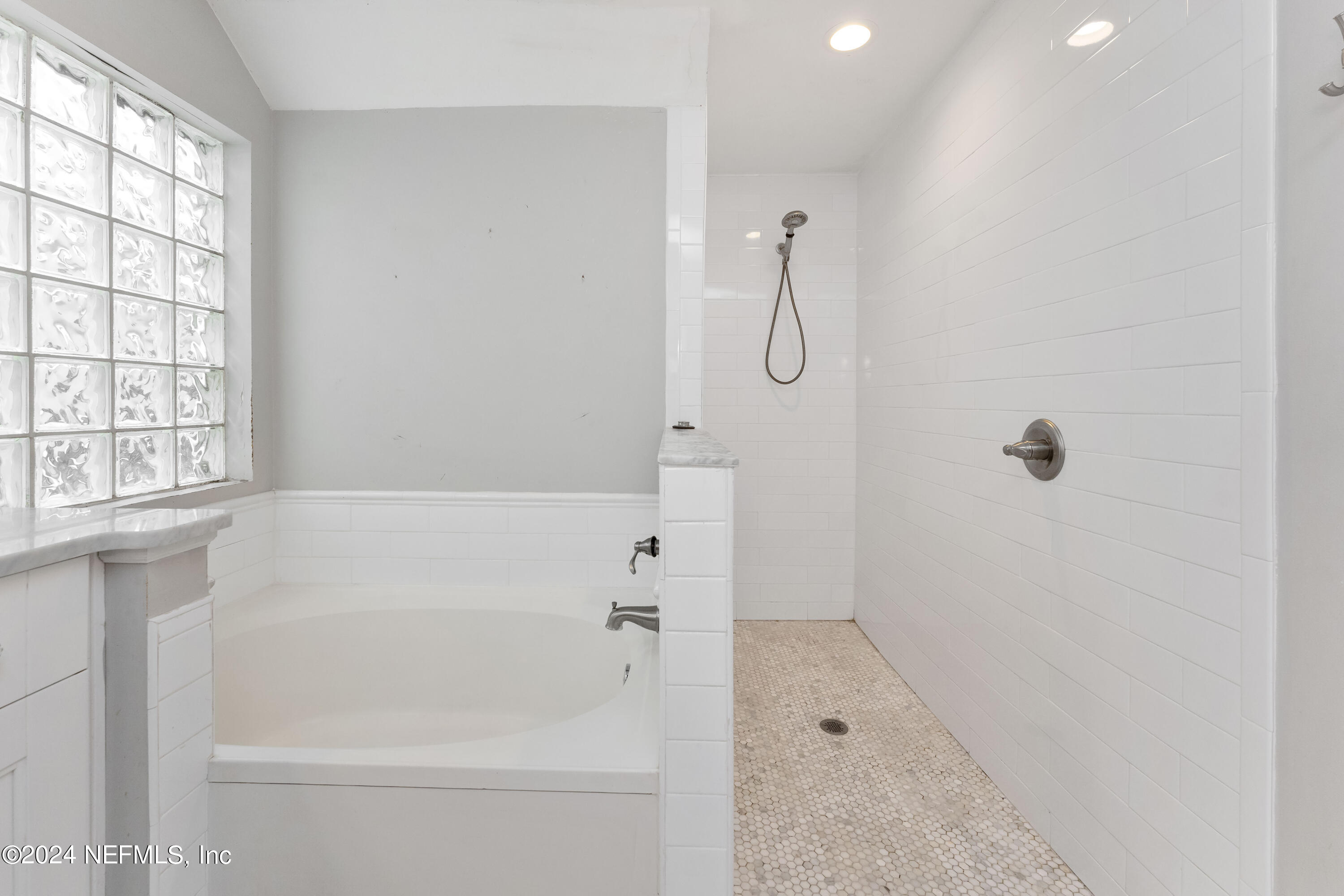 587 Selva Lakes Circle Atlantic Beach, FL 32233 - Photo 15 of 31 a bathroom with a bathtub and a shower