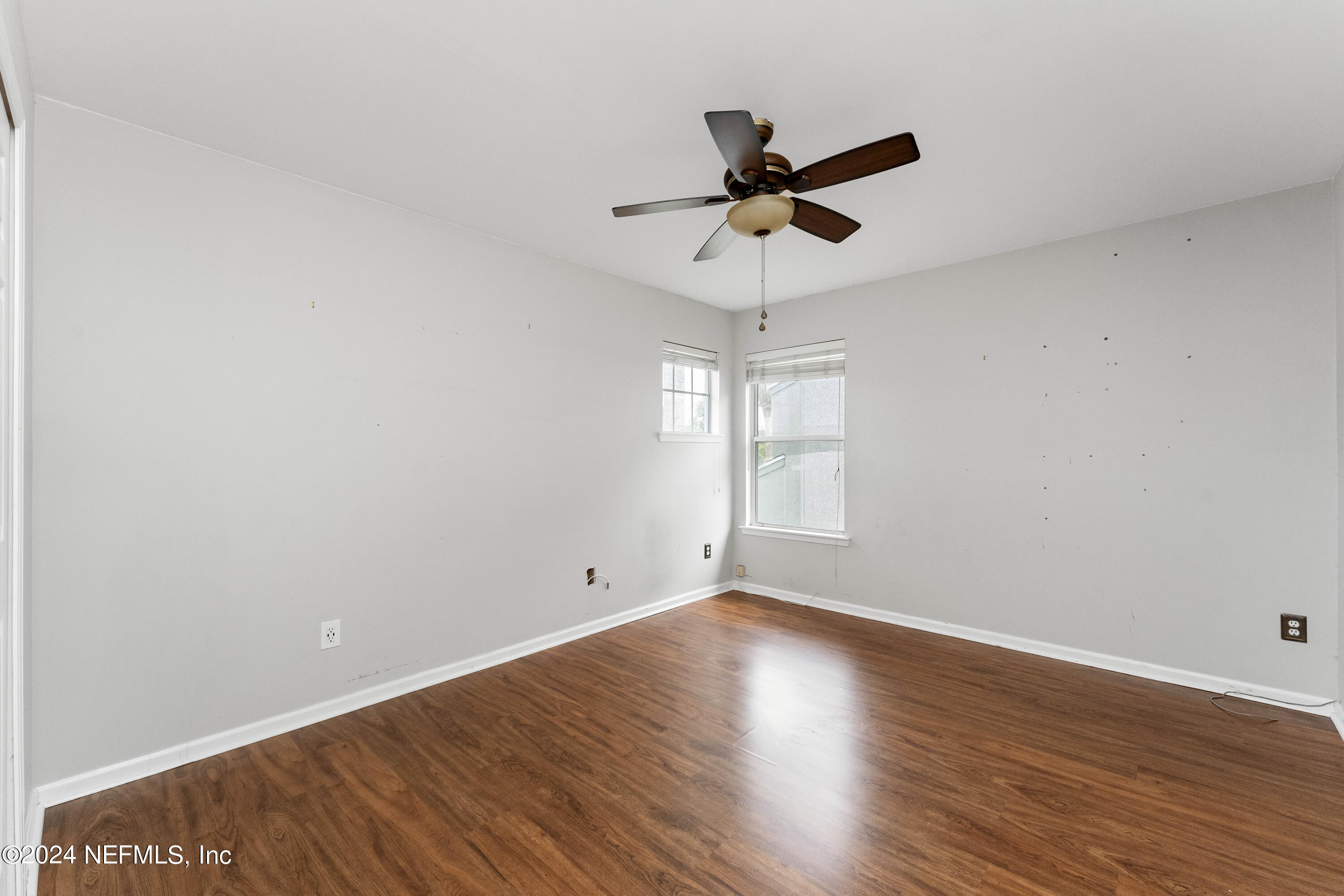 587 Selva Lakes Circle Atlantic Beach, FL 32233 - Photo 17 of 31 a view of a big room with wooden floor closet and windows