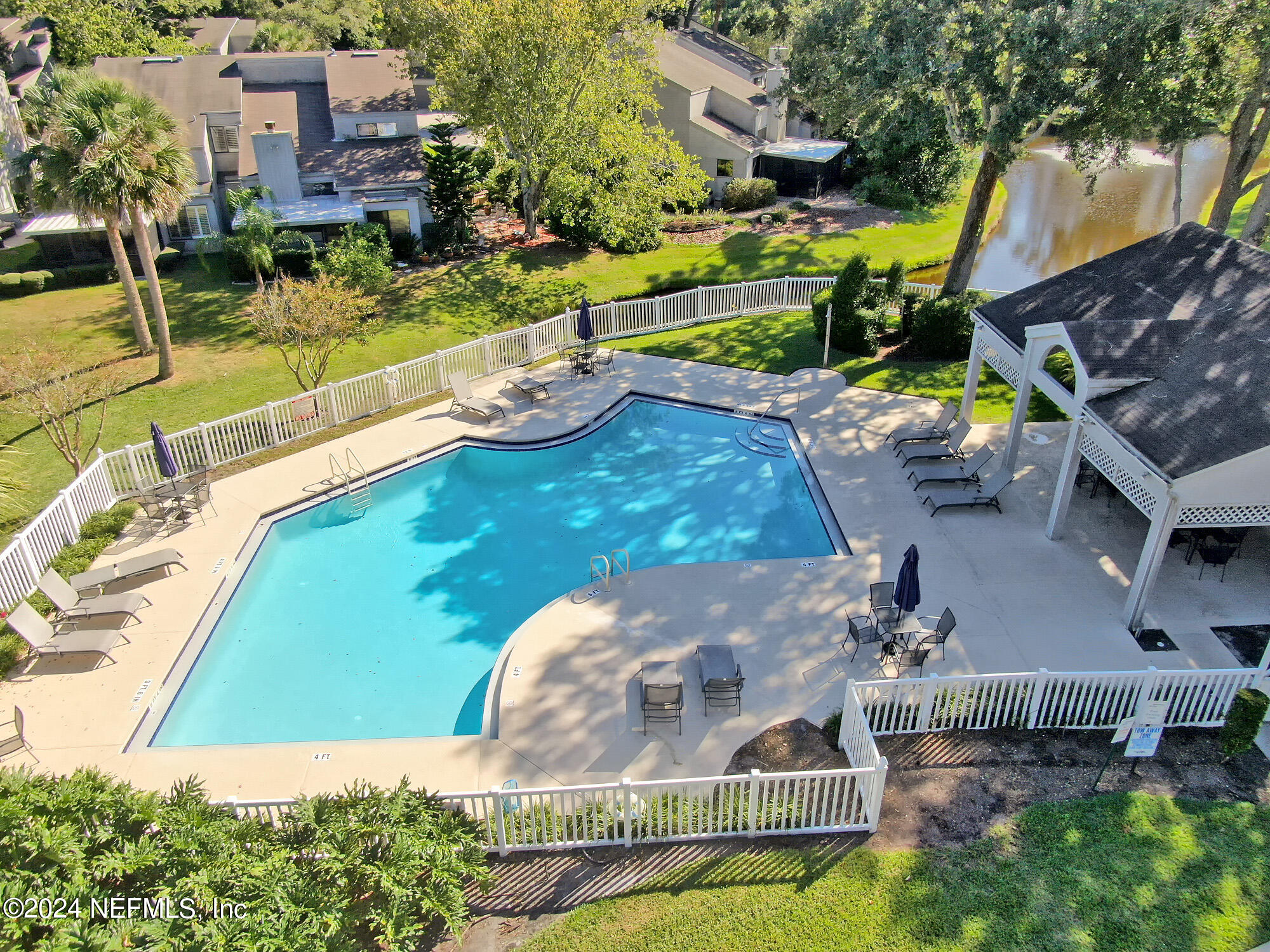587 Selva Lakes Circle Atlantic Beach, FL 32233 - Photo 30 of 31 a view of a swimming pool with a patio