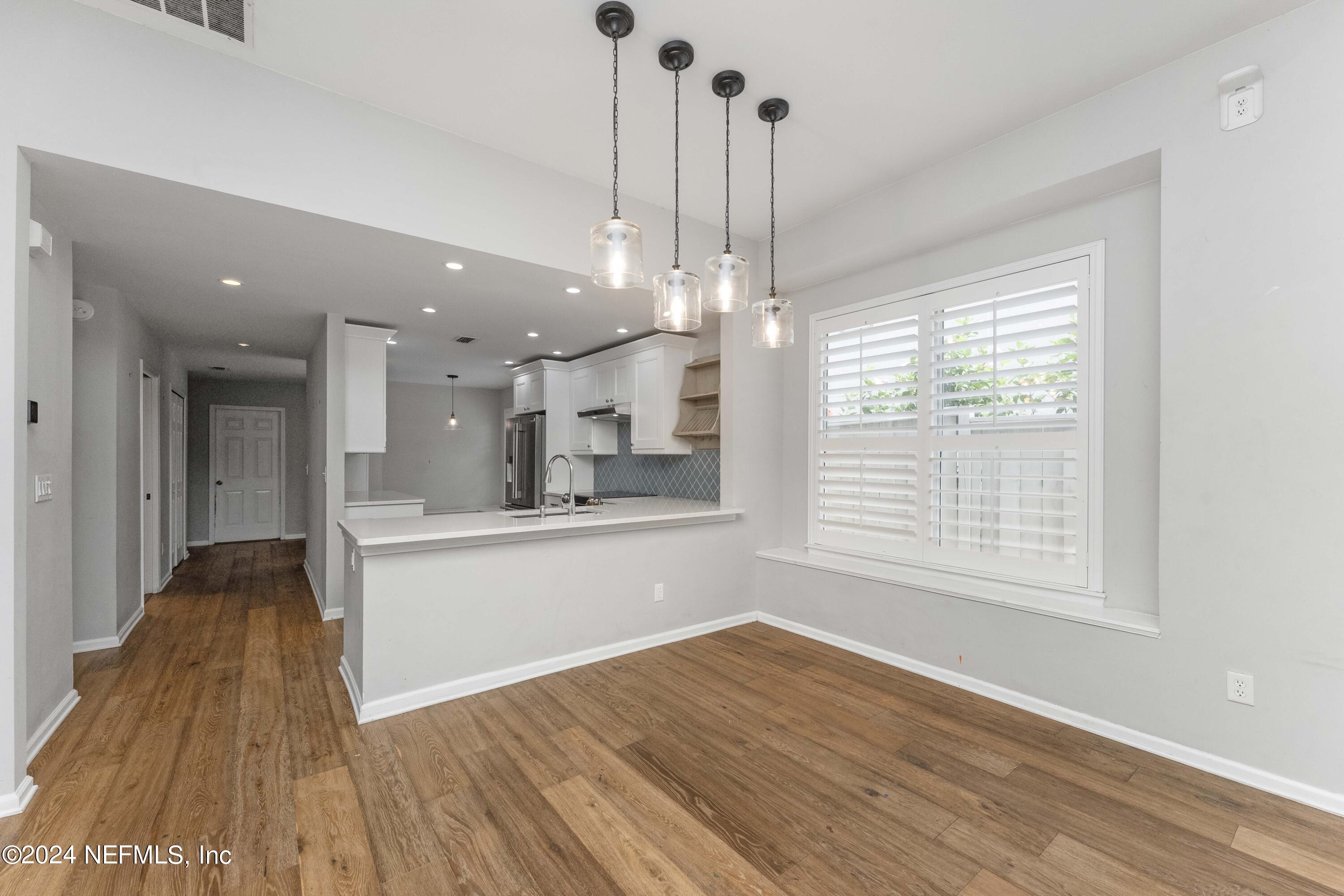 587 Selva Lakes Circle Atlantic Beach, FL 32233 - Photo 4 of 31 a view of a kitchen and wooden floor