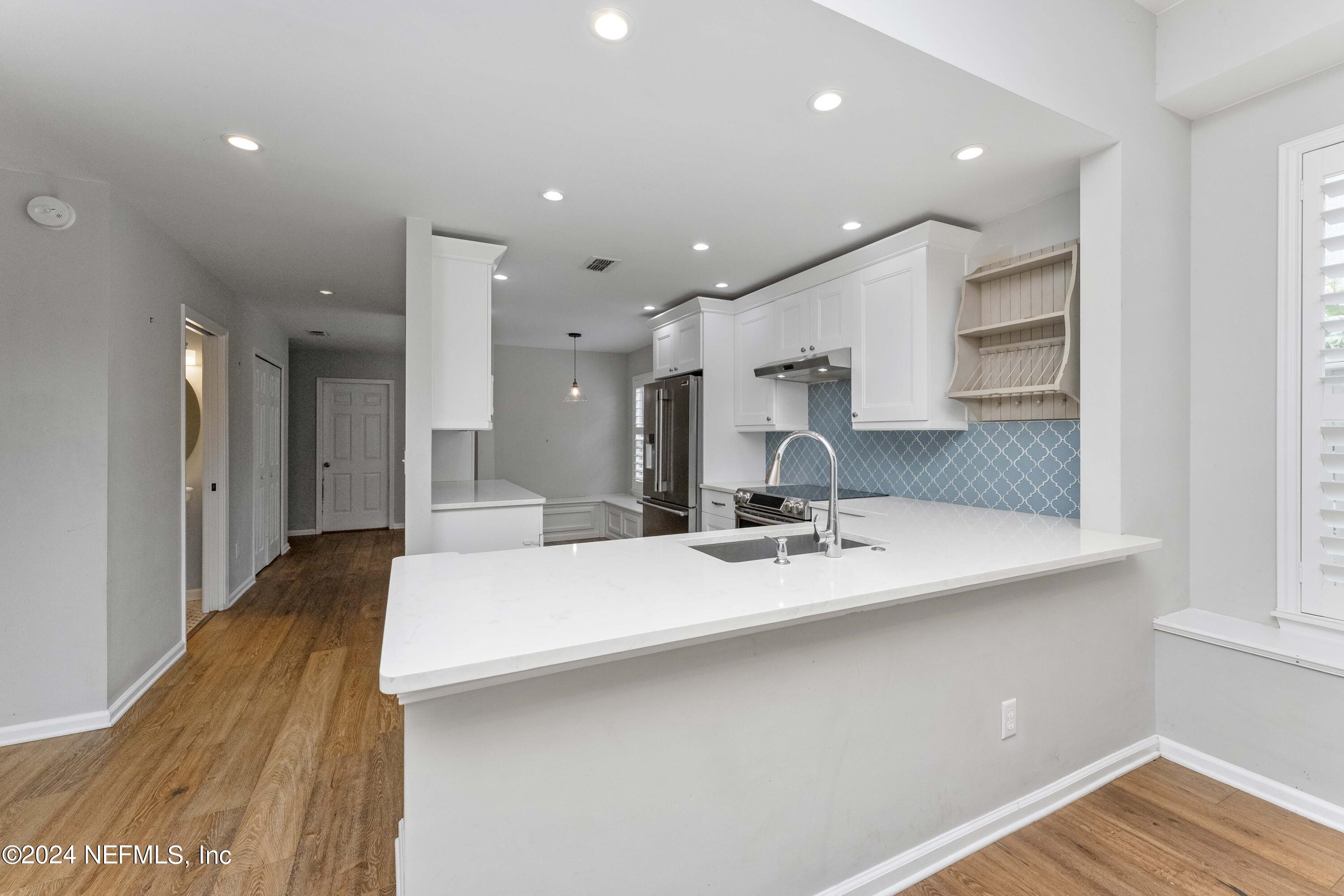 587 Selva Lakes Circle Atlantic Beach, FL 32233 - Photo 5 of 31 a large kitchen with kitchen island a sink stainless steel appliances and cabinets