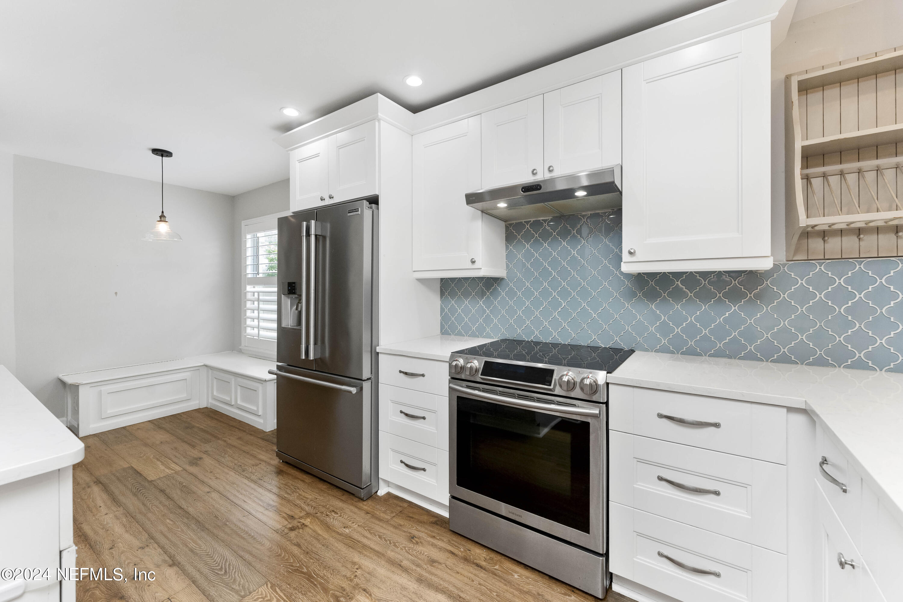 587 Selva Lakes Circle Atlantic Beach, FL 32233 - Photo 7 of 31 a kitchen with stainless steel appliances a stove a microwave and a refrigerator