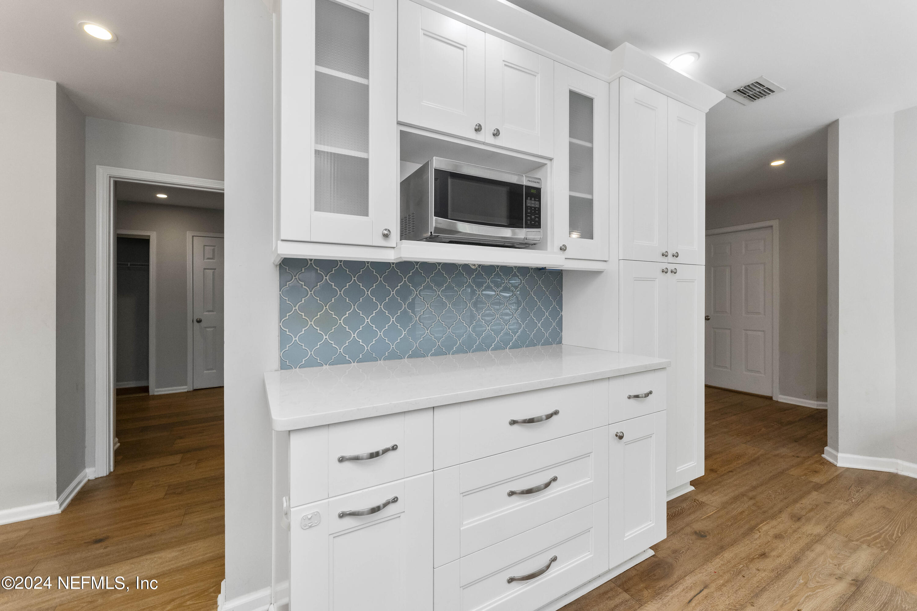 587 Selva Lakes Circle Atlantic Beach, FL 32233 - Photo 8 of 31 a view of cabinets and wooden floor