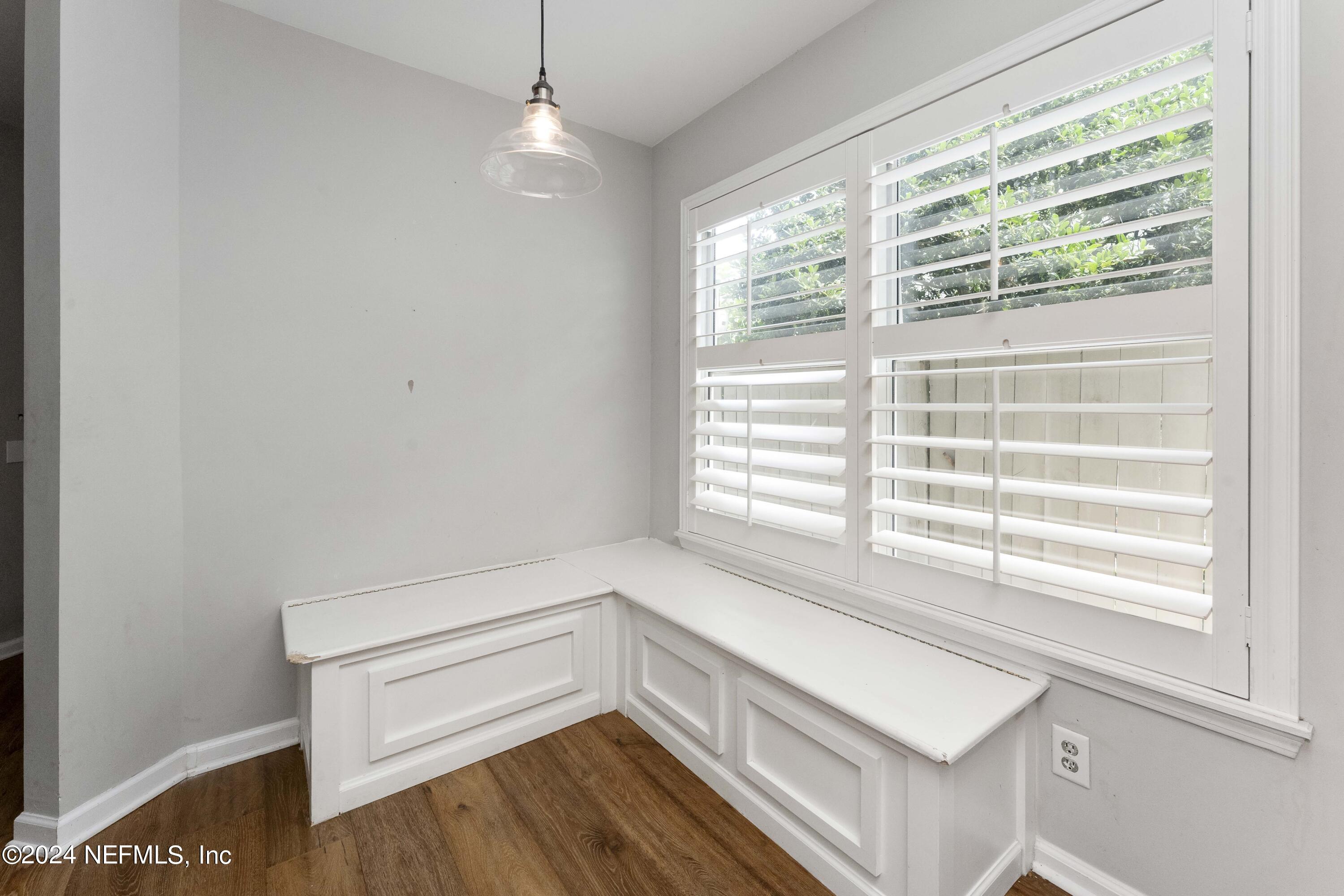 587 Selva Lakes Circle Atlantic Beach, FL 32233 - Photo 9 of 31 a view of an empty room with a window and wooden floor