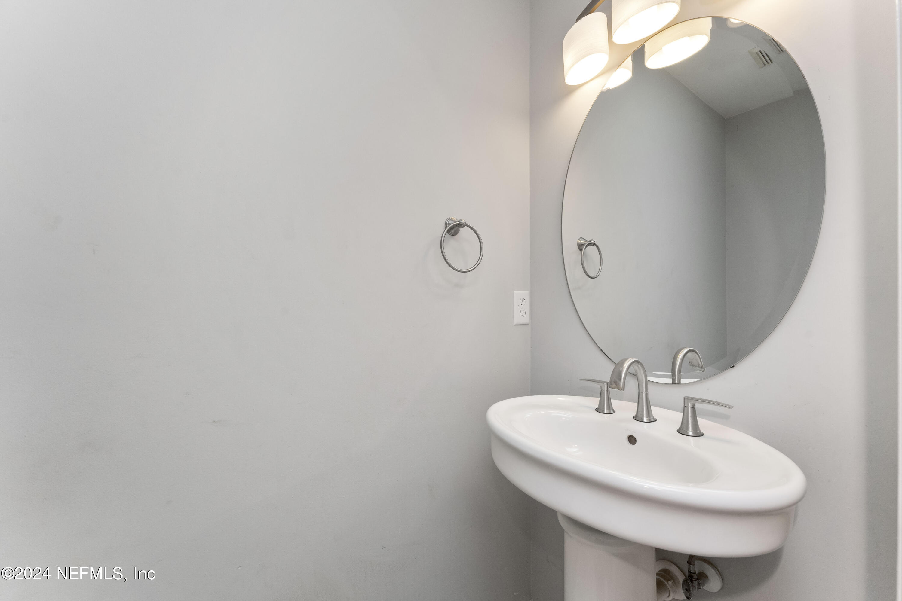 587 Selva Lakes Circle Atlantic Beach, FL 32233 - Photo 10 of 31 a bathroom with a sink and mirror