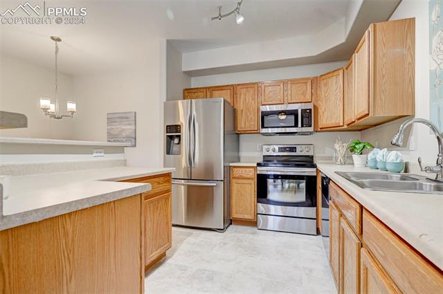 2094 Legacy Ridge View, Unit 107 Colorado Springs, CO 80910 - Photo 6 of 19 Ample counter space and plenty of cabinets for storage. Refrigerator is being assessed for functionality and will be included if it can be repaired.
