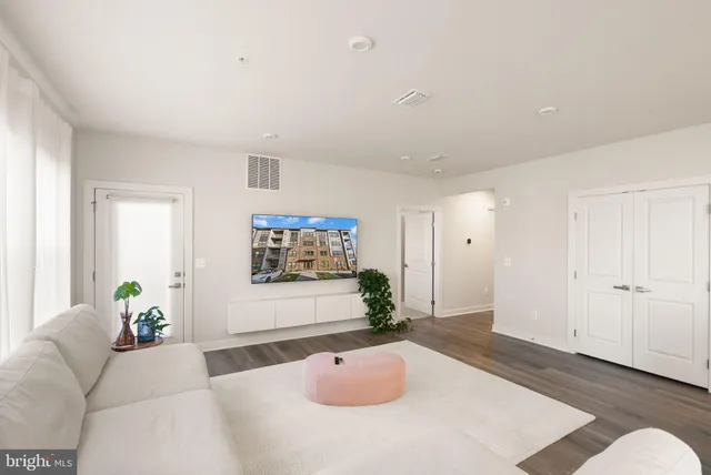 a living room with furniture potted plant and windows