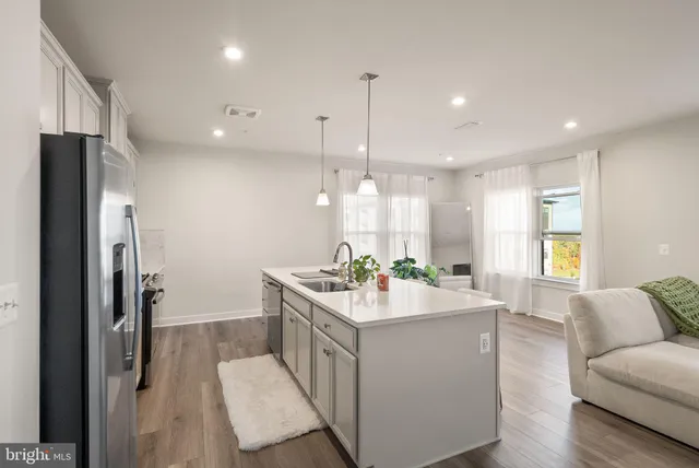 a kitchen with a sink stove and refrigerator