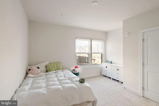 a bed room with furniture and a large window