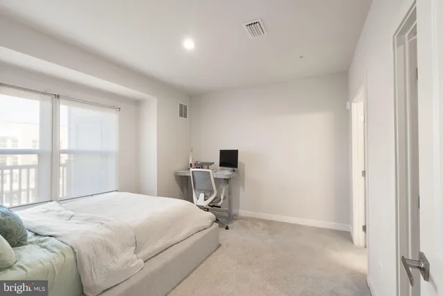 a bedroom with a bed and a desk