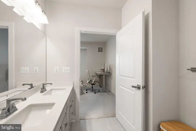 a en suite bathroom with a sink a toilet and a mirror