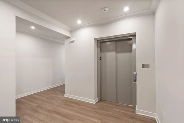 an empty room with wooden floor and closet