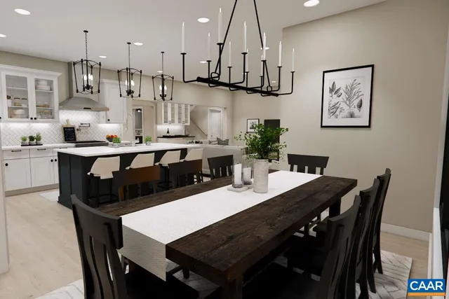 a kitchen with stainless steel appliances kitchen island a table and chairs in it