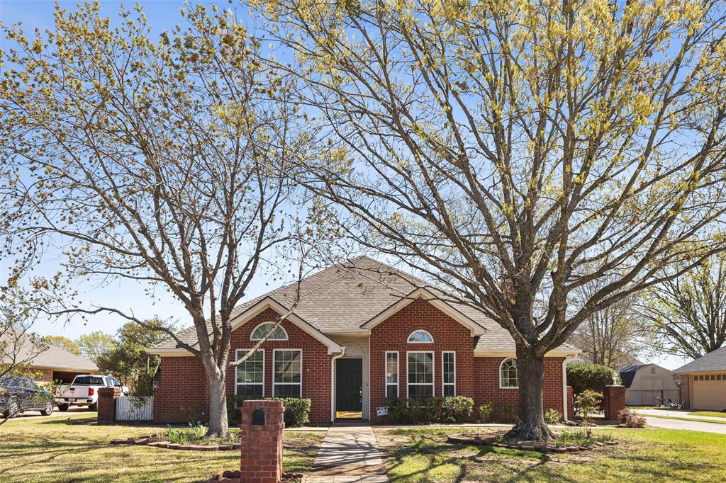 a front view of a building with trees and snow in it