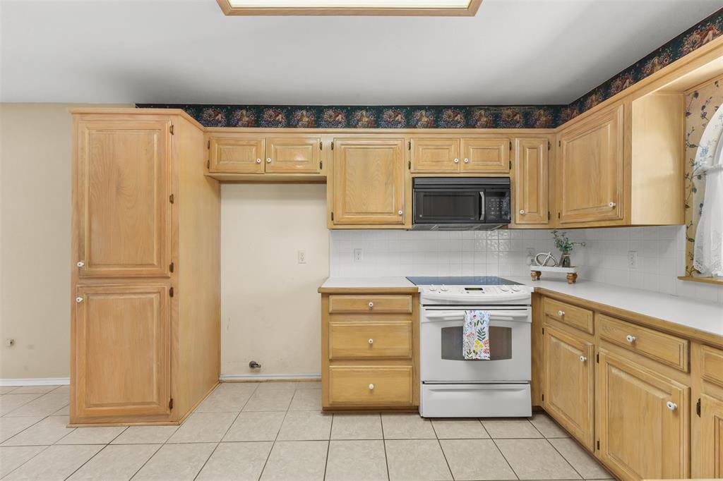 1516 Ryan Road Sulphur Springs, TX 75482 - Photo 14 of 37 a kitchen with stainless steel appliances granite countertop a refrigerator and a stove top oven