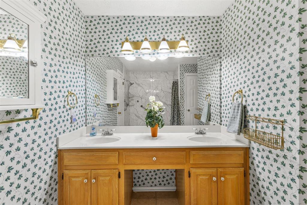 1516 Ryan Road Sulphur Springs, TX 75482 - Photo 24 of 37 a bathroom with a sink a mirror and vanity