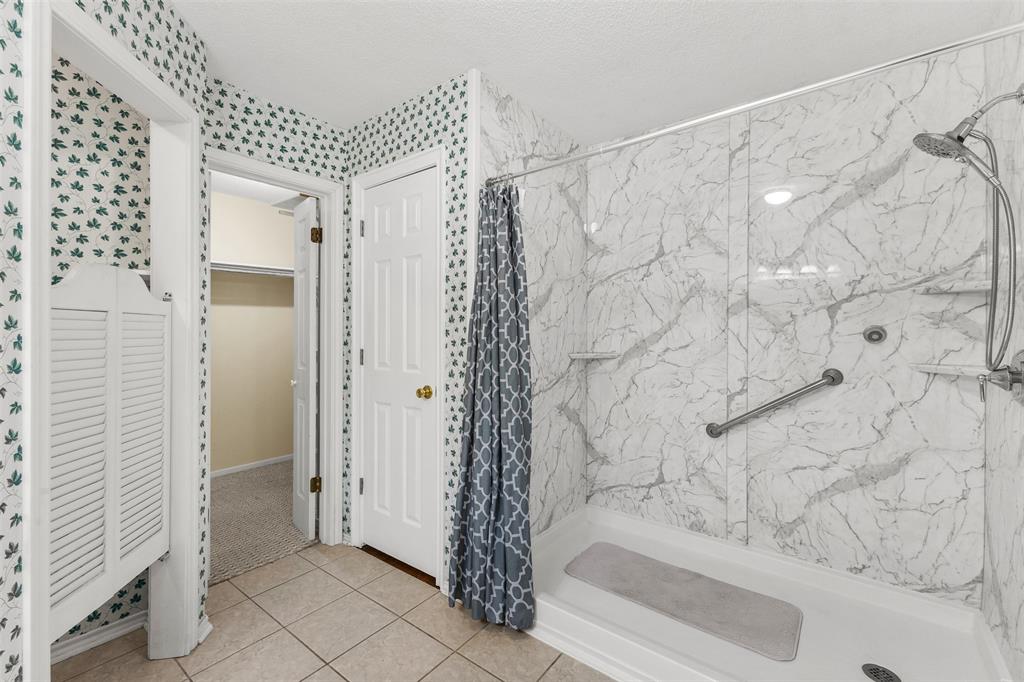 1516 Ryan Road Sulphur Springs, TX 75482 - Photo 25 of 37 a bathroom with a shower curtain and a sink