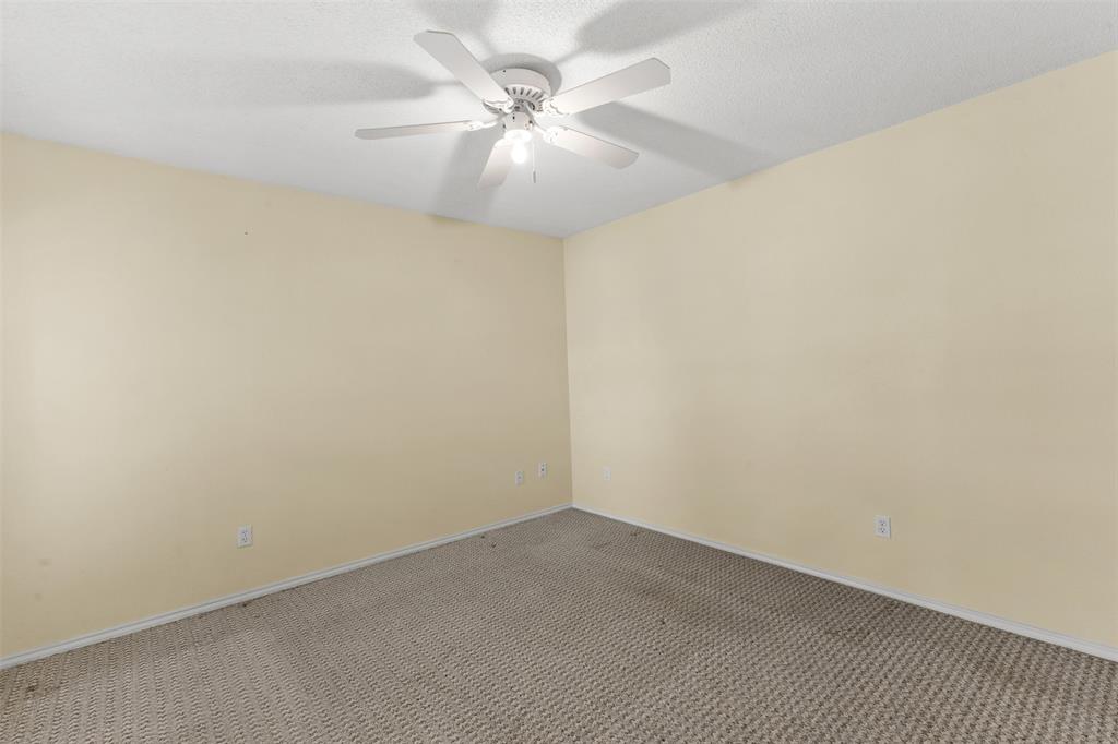 1516 Ryan Road Sulphur Springs, TX 75482 - Photo 30 of 37 an empty room with a chandelier fan and windows