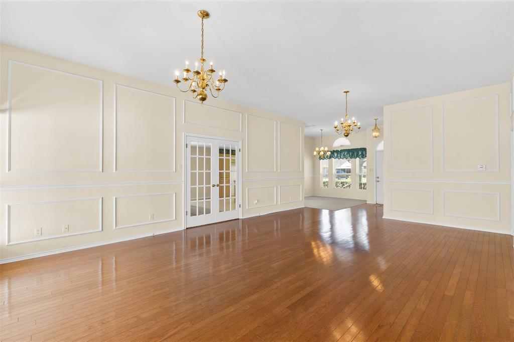 1516 Ryan Road Sulphur Springs, TX 75482 - Photo 5 of 37 a view of an empty room with a window and wooden floor