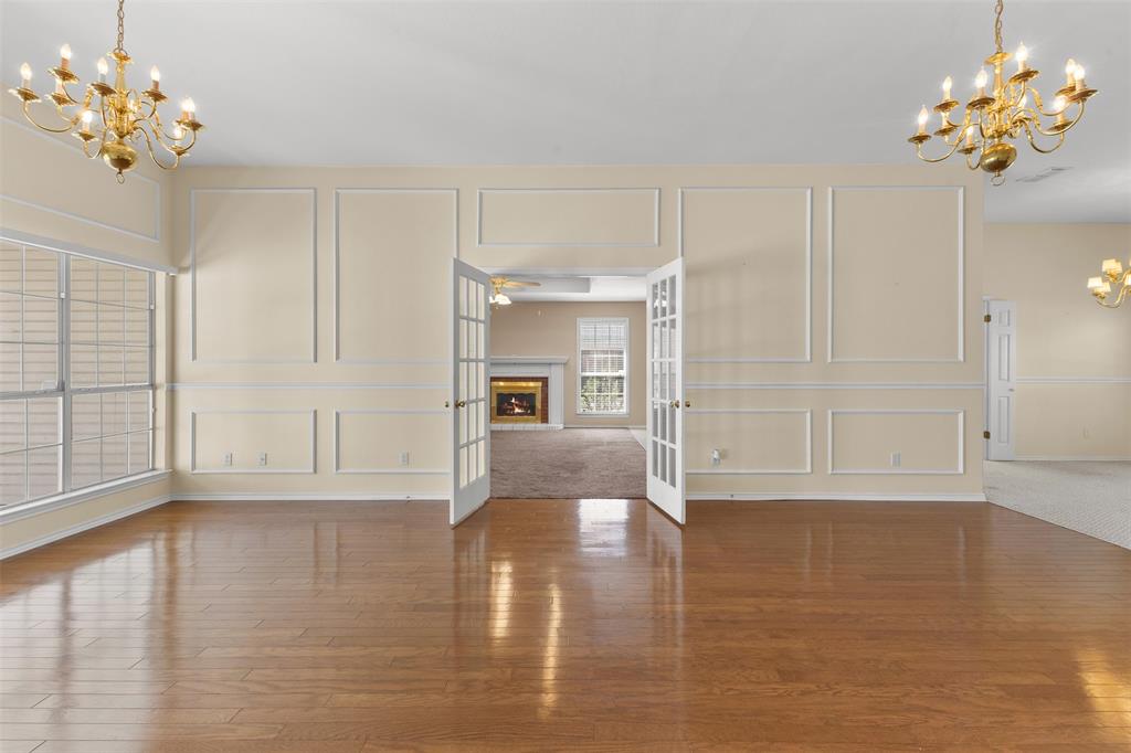 1516 Ryan Road Sulphur Springs, TX 75482 - Photo 6 of 37 a view of an empty room with chandelier fan and wooden floor
