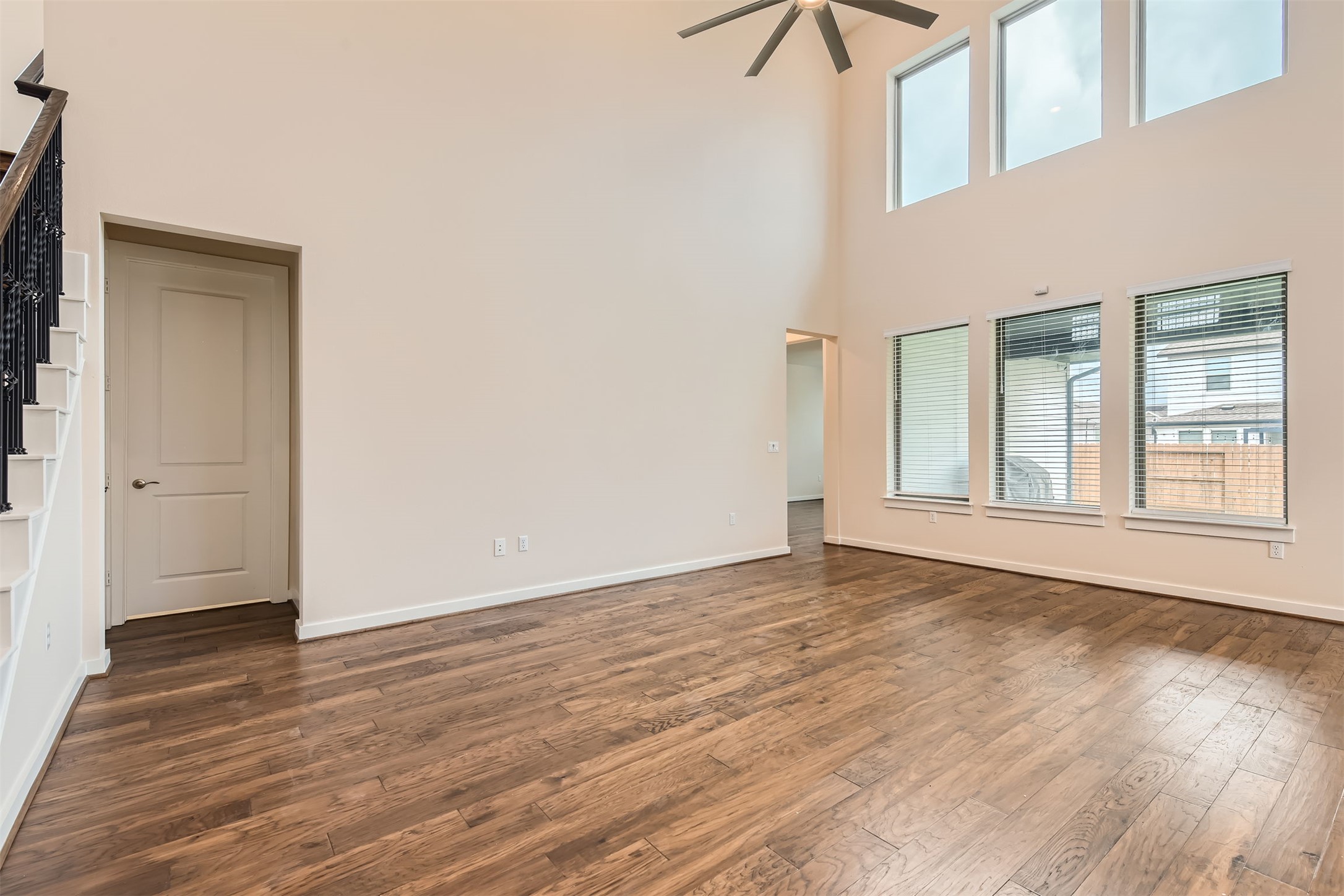 8313 Spire View Austin, TX 78744 - Photo 6 of 33 Natural light floods this spacious living area with soaring ceilings and rich hardwood flooring.