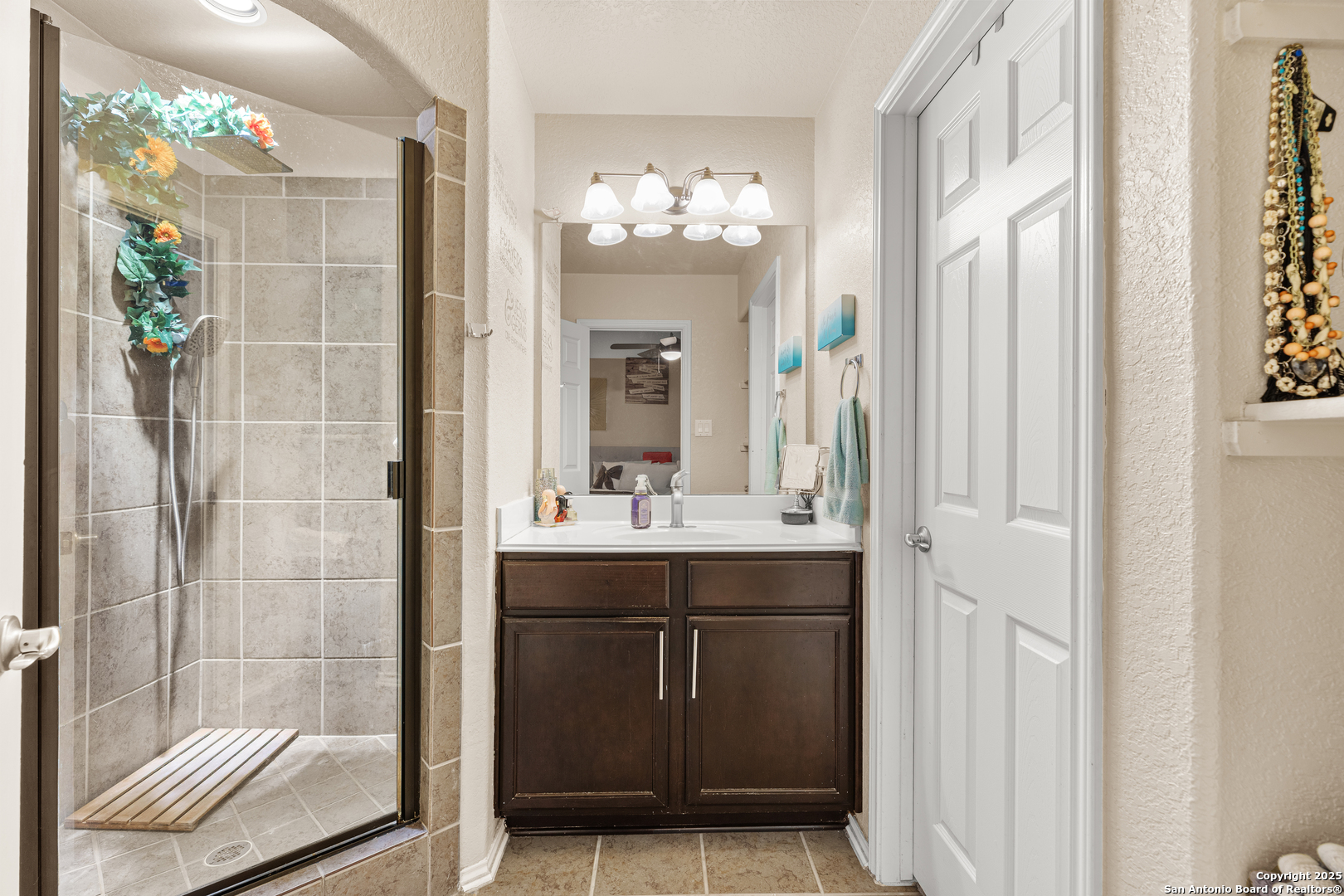 3819 Bacall Way Converse, TX 78109 - Photo 12 of 19 a bathroom with a sink mirror and a shower