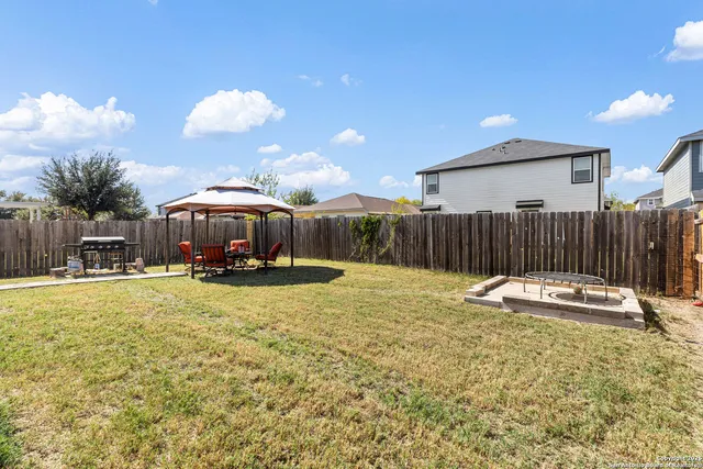 a swimming pool with outdoor seating and yard