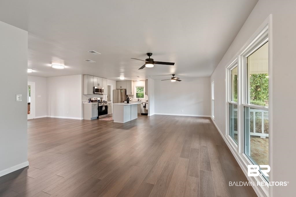 554 Stuart Street Daphne, AL 36526 - Photo 36 of 49 Unfurnished living room with ceiling fan and dark hardwood / wood-style floors