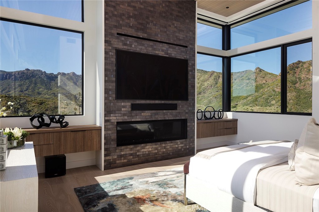 12530 Stagecoach Road Malibu, CA 90265 - Photo 16 of 45 a living room with furniture a flat screen tv and a fireplace