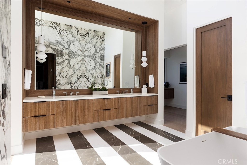 12530 Stagecoach Road Malibu, CA 90265 - Photo 18 of 45 a room with a black white checkered floor with a large mirror and a sink